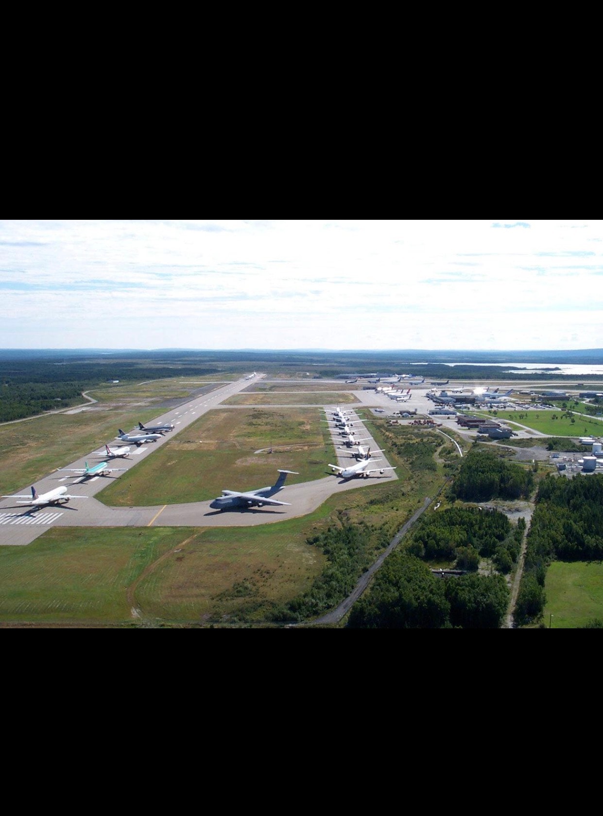 An aerial view of Gander International Airport shows the scale of the aircraft diversion during Operation Yellow Ribbon. Dozens of planes were parked across the airfield as American airspace remained closed. (File photo / Public domain)